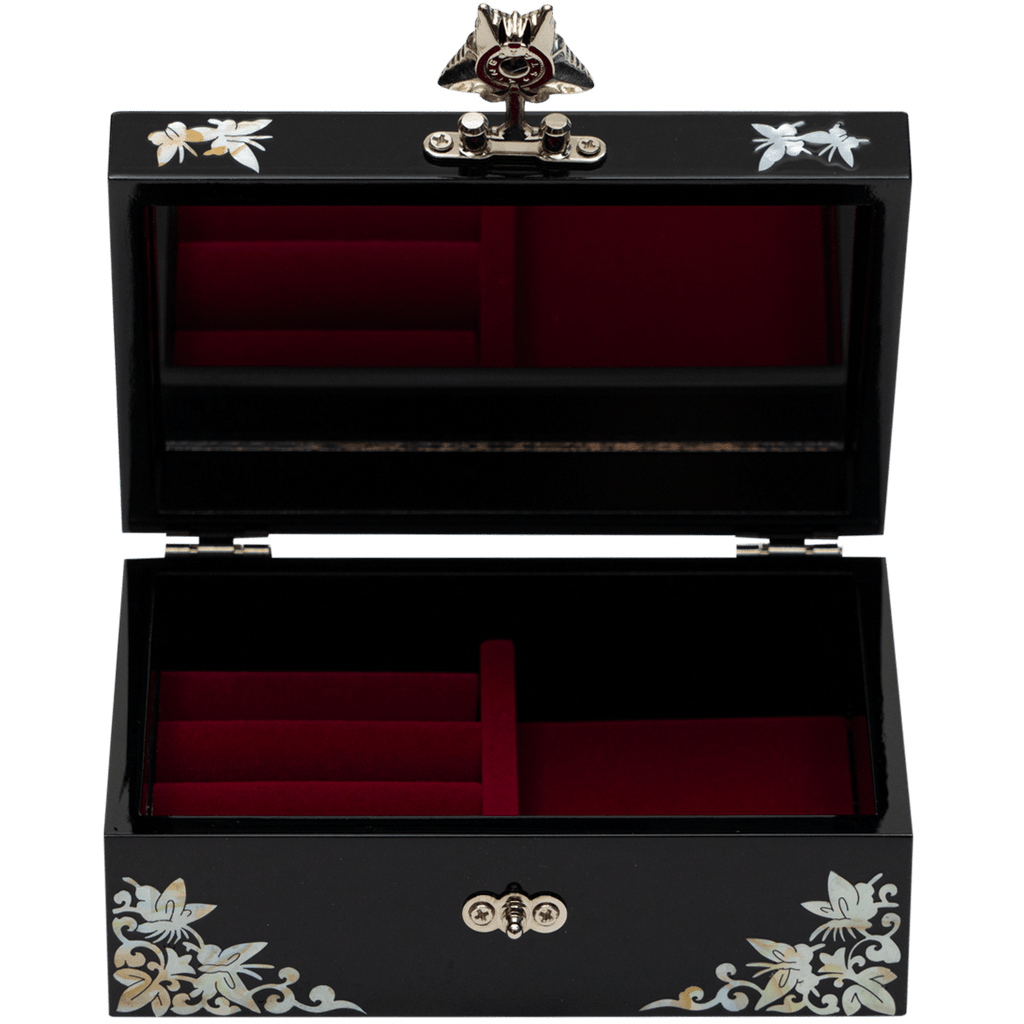  Inside the black jewelry box, a mirror and plush red velvet lining provide a soft cushion for precious items, combining elegance with functionality.