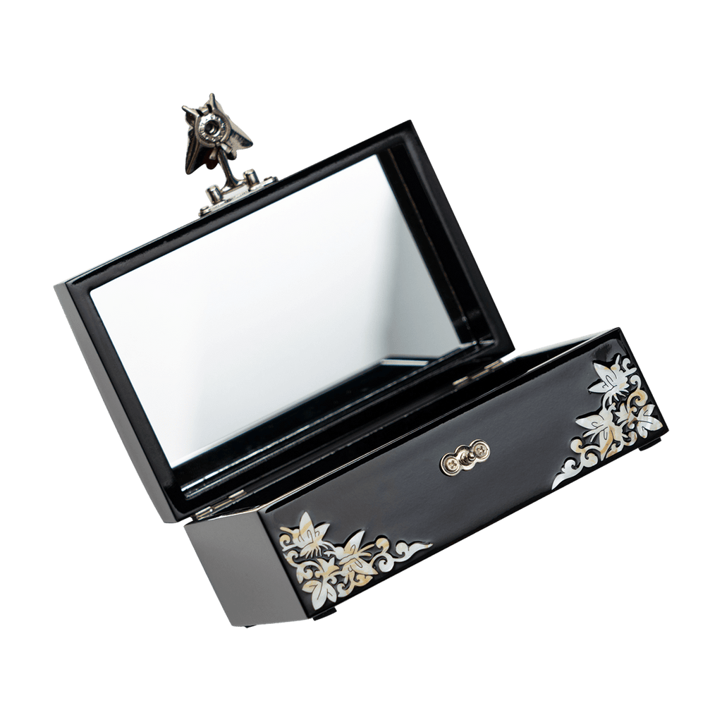 An open black jewelry box with a mirror in the lid and mother-of-pearl flower inlay
