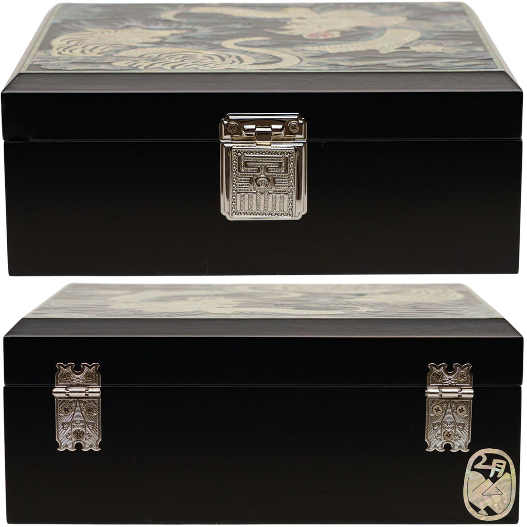 A black mother of pearl box with intricate clasps on the front and side, and a traditional design on the top.