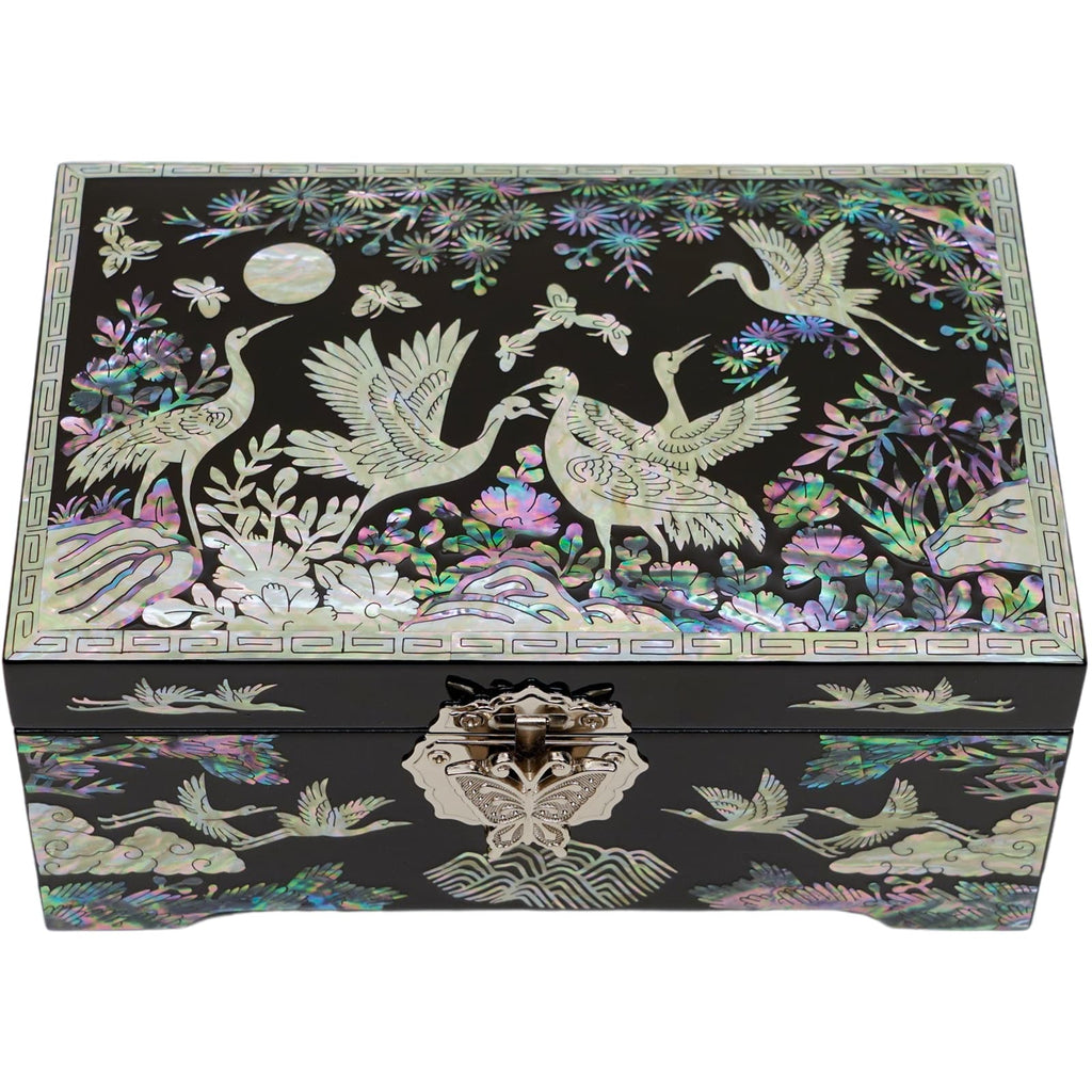  Decorative black jewelry box with mother-of-pearl inlay, featuring cranes and floral patterns, a metal clasp with butterfly design, and detailed borders.