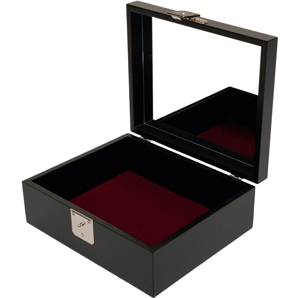 An open black box with a velvet-lined bottom and a reflective interior lid, featuring a mother of pearl design on the exterior.
