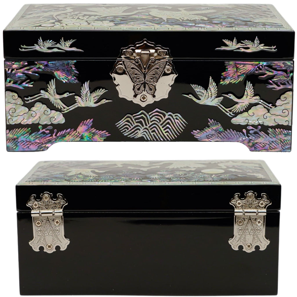  The image depicts a decorative jewelry box with a mother-of-pearl inlay design featuring cranes and nature motifs. It has a clasp with butterfly detail and a glossy finish.