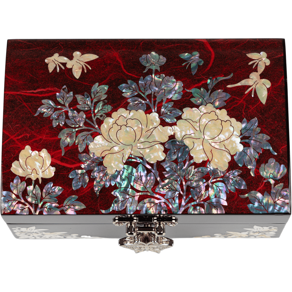 A vibrant mother-of-pearl jewelry box with floral motifs and fluttering butterflies on a glossy red background, exuding elegance and craftsmanship.