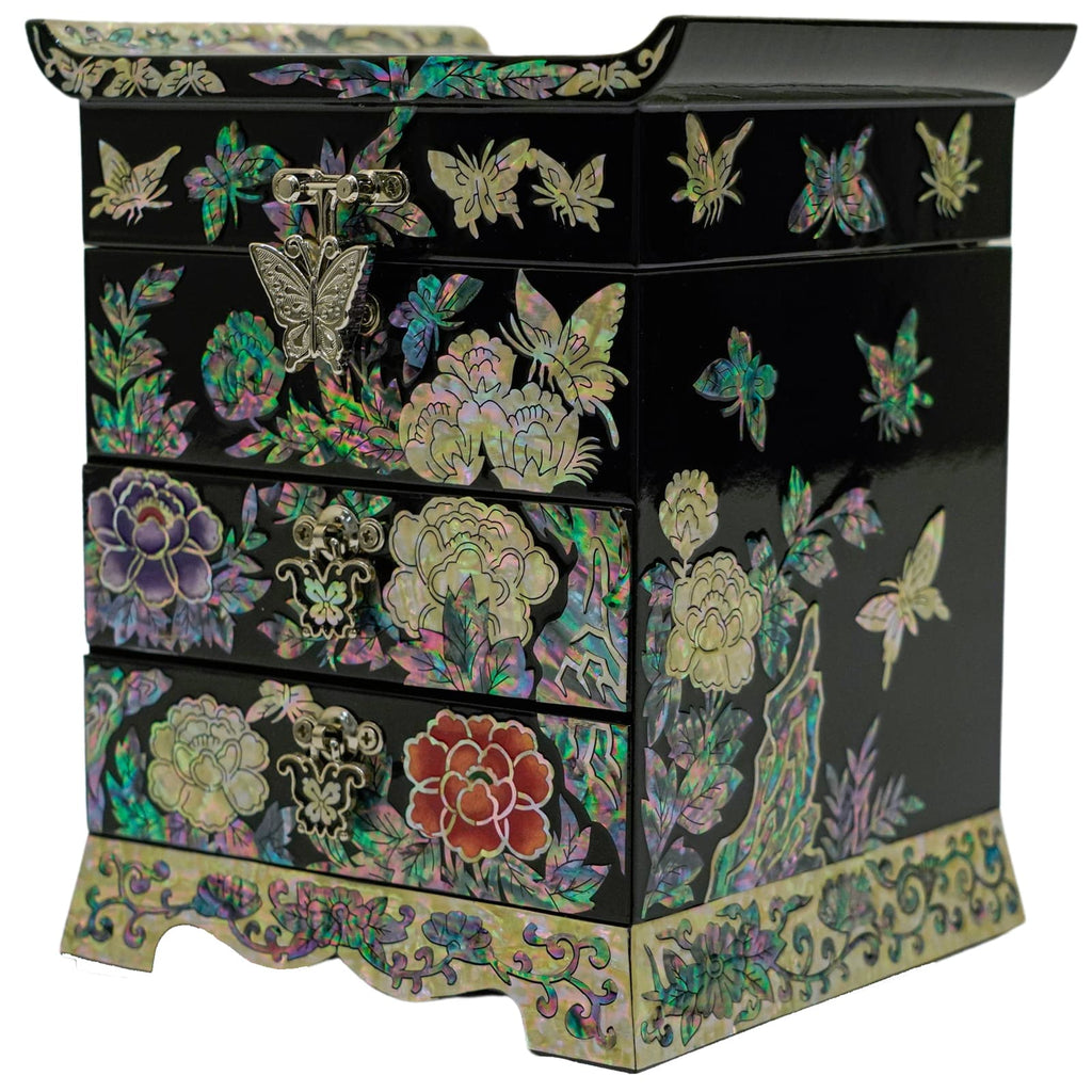  A black jewelry box with a right side adorned with mother-of-pearl flowers and butterflies, featuring ornate metal clasps.