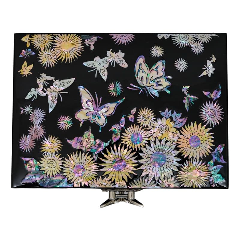A jewelry box with intricate mother-of-pearl inlays, showcasing a pattern of sunflowers and butterflies on a black backdrop, with a metal clasp at the front