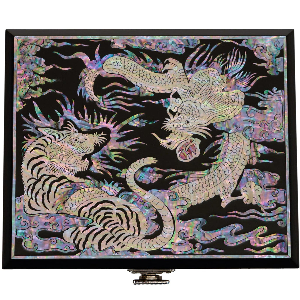 A traditional Korean mother of pearl box featuring a design of a tiger and a dragon.