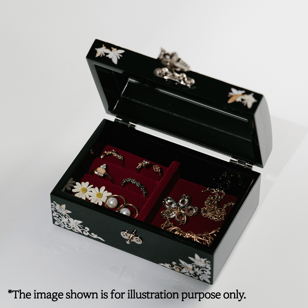  A black jewelry box with mother-of-pearl inlay is open, revealing a mirror lid and a red velvet interior with assorted jewelry, as an example display.