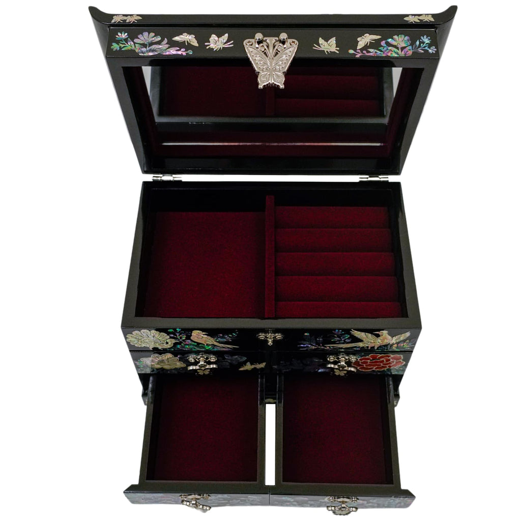 A black jewelry box with an open lid and drawers, showcasing a red velvet interior, adorned with a butterfly and floral mother-of-pearl inlay on the exterior.