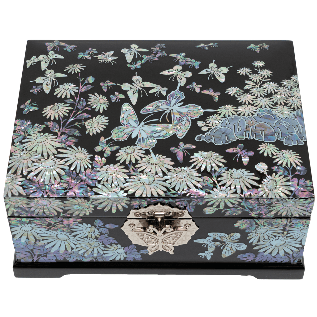 A black lacquered jewelry box with intricate mother of pearl inlay featuring a large butterfly, floral patterns, and a front clasp detail.