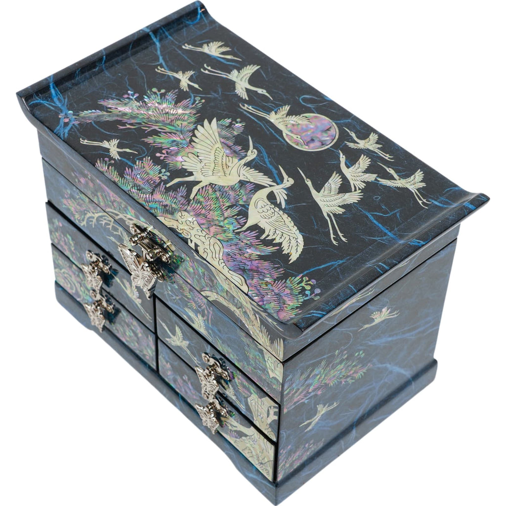 A blue Korean mother-of-pearl jewelry box adorned with intricate crane and floral inlays, featuring multiple drawers and a hinged lid.