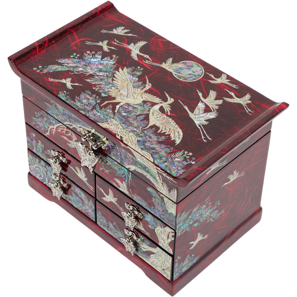 A Korean mother-of-pearl jewelry box with a crane and pine tree design, featuring detailed inlays and multiple compartments.